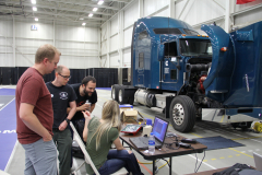 Discussing-strategy-in-front-of-Cummins-truck